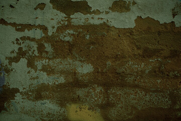 Background texture of grunge weathered plaster on an old wall with flaking white paint in a full frame view