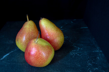 Three pears on black