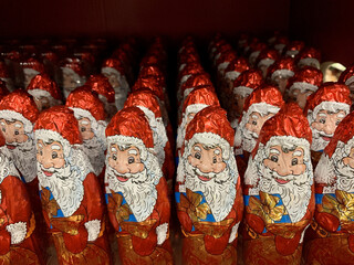 Candy in the form of Santa Claus. Christmas sweets on a supermarket shelf. Many bright toys: Santa Claus.