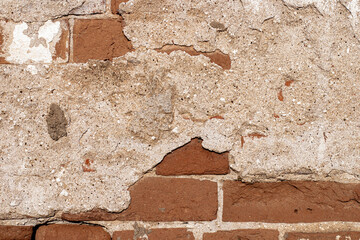 Texture of old brick wall with destroyed plaster..Classic brickwork as a backdrop or backdrop.