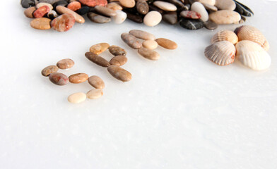 Sea pebble lettering: SPA. Marine background with seashells.