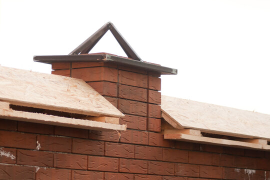 Construction of a brick fence. Installation of ebb, hoods or parapets