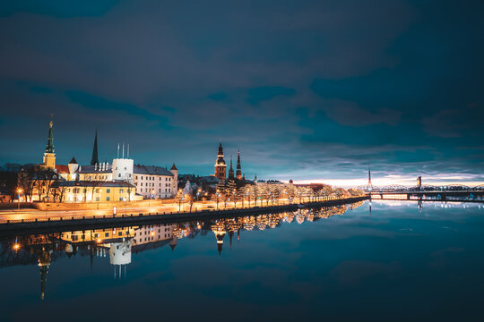 Riga, Latvia, Europe. Cityscape In Morning Time. Night View Of Castle, Dome Cathedral And St. Peter's Church. Popular Place With Famous Landmarks. UNESCO. Old Town In Street Christmas Decoration