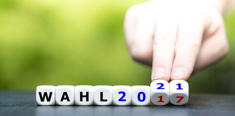 Symbol für die Bundestagswahlen 2021 un Deutschland. Hand dreht Würfel und ändert den Ausdruck...