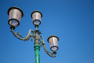 Fototapeta na wymiar old street lamp on blue sky