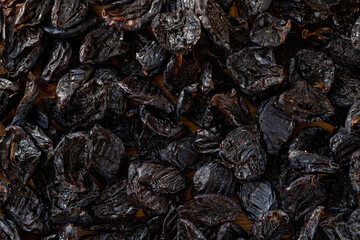 Dried plums or prunes fruit background texture. Top view