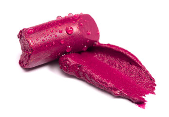 Cut Tube of Lipstick with a Swatch of Color on a White Background