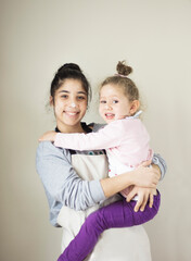 Two sweet little girl are happy and hugging each other.