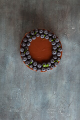 Chocolate brown cheesecake with fresh blueberries on vintage concrete background.