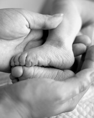 Small feet of a newborn close up. The first days of a baby's life.