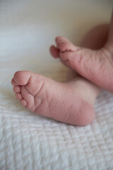 Small feet of a newborn close up. The first days of a baby's life.