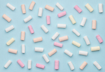 Colorful marshmallows on blue background