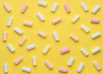 colorful marshmallows on yellow background