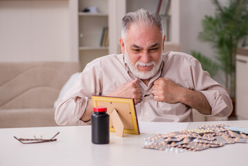 Old sick man suffering at home
