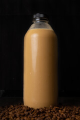 a bottle of coffee latte in dark background.