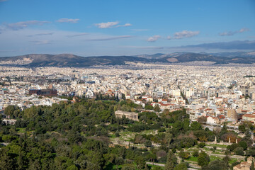 Athens - December 2019: view of the city from the Acropolis with Temple of Hephaestus