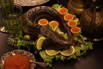 Baked sturgeon with black and red caviar, white wine and vodka