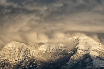 Stunning view of a snow capped mountain range during a beautiful sunset. Italy.