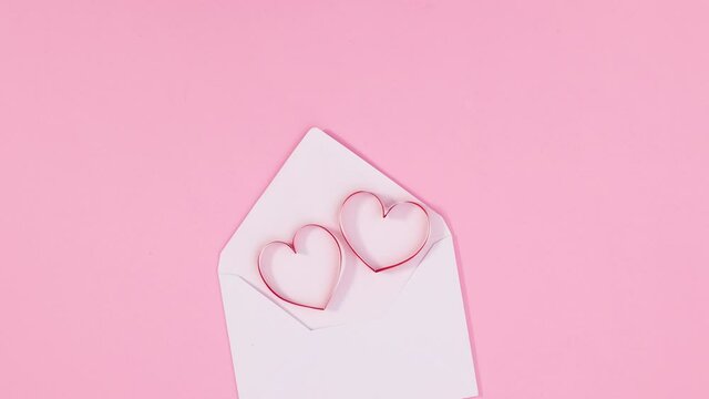 Two romantic hearts for Valentine's say appear from envelope. Stop motion