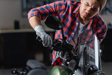 Fototapeta na wymiar young mechanic checking brake handle on motorbike handlebar