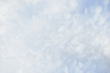 Hoarfrost background texture. Fresh ice and snow winter backdrop with snowflakes and mounds. Seasonal wallpaper. Frozen water geometrical shapes and figures. Cold weather atmospheric precipitation.
