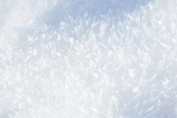 Hoarfrost background texture. Fresh ice and snow winter backdrop with snowflakes and mounds. Seasonal wallpaper. Frozen water geometrical shapes and figures. Cold weather atmospheric precipitation.