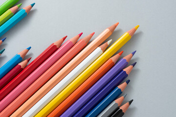 Colorful pencils in the case isolated on the gray background.