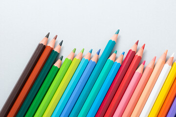 Colorful pencils in the case isolated on the gray background.