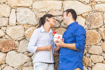 Young couple  Hugging, kissing and enjoying spending time together while celebrating Saint...
