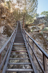 Fototapeta premium Long wooden staircase in the mountains at sunset
