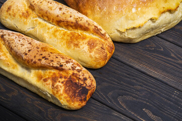 Bakeds loafs of Ukrainian national bread on a black vintage table