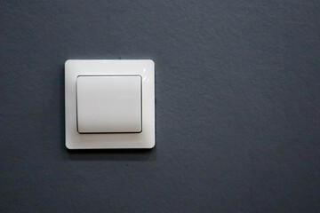 electricity white light switch on the grey wall