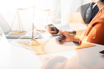 justice and law concept.Male judge in a courtroom on wooden table and Counselor or Male lawyer working in office. Legal law, advice and justice concept.
