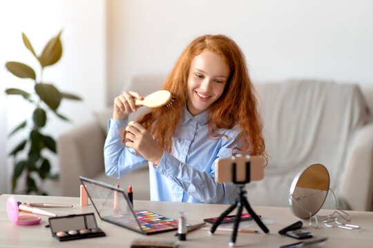 Red-Haired Teen Girl Recording Her Beauty Blog, Brushing Hair