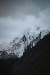 Dramatic clouds covering the peak of a snowy mountain in Pyrenees