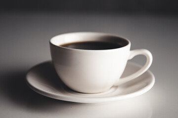 Office desk table with supplies, coffee cup and flower. Top view