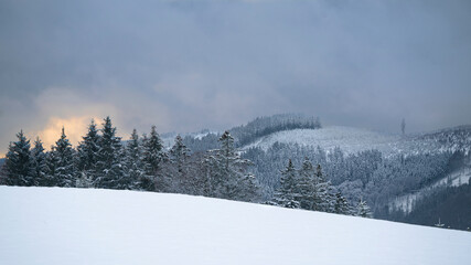 Snowy landscape on a peak of Sauerland mountains. Snow covered forests near and far. The sun shines...