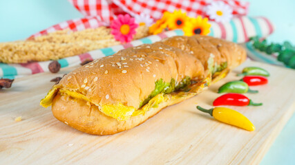 Selective Focus - Homemade Roti John - bread with omelette in a plate on a wooden cutting board
