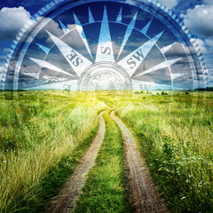 Country road and the silhouette of a compass in the sky as a symbol of travel, search and...