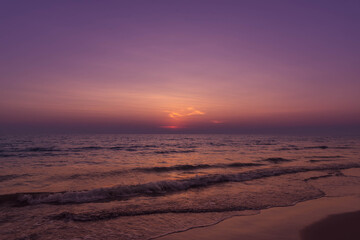 Nature in twilight period which including of sunrise over the sea and the nice beach. Summer beach with blue water and purple sky at the sunset.