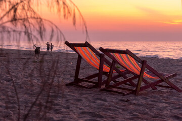 Nature in twilight period which including of sunrise over the sea and the nice beach. Summer beach with blue water and purple sky at the sunset.