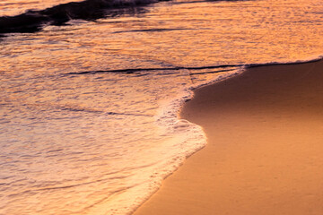 Nature in twilight period which including of sunrise over the sea and the nice beach. Summer beach with blue water and purple sky at the sunset.