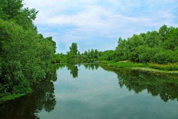 Fototapeta na wymiar Landscape with river in summer. River landscape with green sides