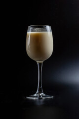 milk in a glass on a black background