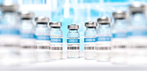Immunity from coronavirus. Panoramic photo of a lot ampoules with COVID-19 corona virus vaccine for injection on laboratory background. Coronavirus vaccine manufacture, worldwide vaccination