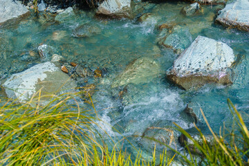 Cool water of Hooker River flowing over rocky river bed.