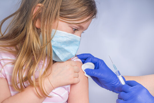 Get coronavirus vaccine concept, getting covid-19 vaccination, Doctor injecting vaccination in arm of caucasian little child girl,healthy and medical concept