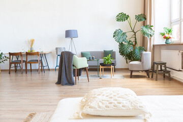 interior of stylish loft. spacious apartment with large windows, parquet on the floor and light walls. closeup view of shelving with different small things for decoration