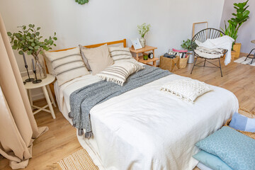 interior of stylish loft. spacious apartment with large windows, parquet on the floor and light walls. closeup view of shelving with different small things for decoration