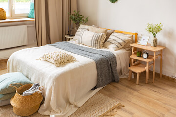 interior of stylish loft. spacious apartment with large windows, parquet on the floor and light walls. closeup view of shelving with different small things for decoration